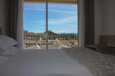 a bedroom with a bed and a large window at Le Concorde in Aix-en-Provence