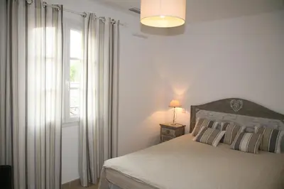 a bedroom with a bed and a window at Golf de Pont Royal Villa les Micocouliers climatisée 4 chambres Piscine chauffée Parking in Mallemort