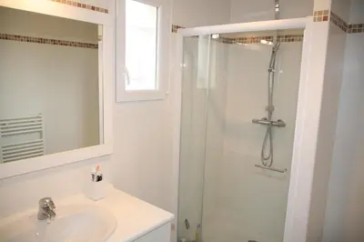 a white bathroom with a shower and a sink at Golf de Pont Royal Villa les Micocouliers climatisée 4 chambres Piscine chauffée Parking in Mallemort