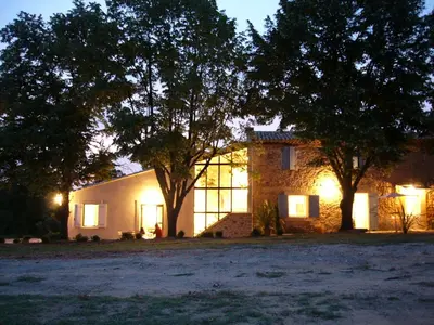 a house lit up at night with trees in front at Mas Boudeissoun - Grain de Muscat - Baignade à 600 m in Mormoiron