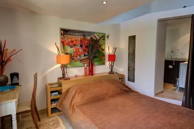 a bedroom with a bed and a painting on the wall at Les Gargoulettes in Lauris