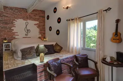 a bedroom with a bed and a brick wall at Les Gargoulettes in Lauris