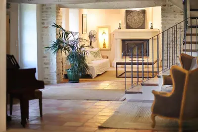 a living room with a couch and a fireplace at Mas des Baussiers in Saint-Martin-de-Castillon