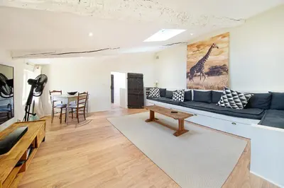 a living room with a blue couch and a table at Mas des Baussiers in Saint-Martin-de-Castillon