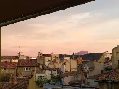 a view of a city with buildings and a mountain at Appart Centre Mairie - Terrasse vue Ste Victoire in Aix-en-Provence