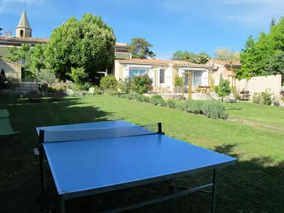 a blue ping pong table in the middle of a yard at Lou Cardalines in Bédoin