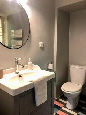 a bathroom with a sink and a toilet and a mirror at B&B Villa Roumanille in Aix-en-Provence