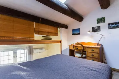 a bedroom with a bed and a desk and a chair at Duplex 6 personnes, ascenseur, zone pietonne, 1 bis Rue Aude in Aix-en-Provence
