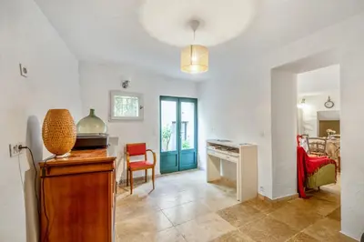 a kitchen with a table and a desk in a room at Charmante Maison à Bonnieux avec Terrasse et Vue sur le Jardin in Bonnieux