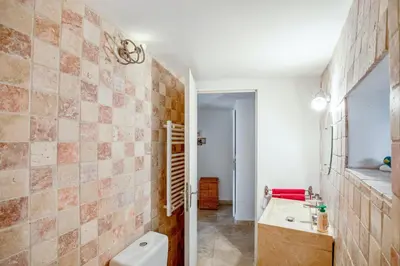 a bathroom with a toilet and a sink at Charmante Maison à Bonnieux avec Terrasse et Vue sur le Jardin in Bonnieux