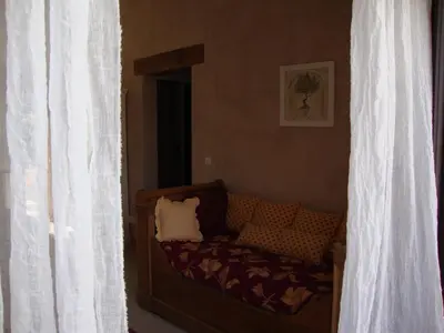 a living room with a couch and a window at La Guéritaulde in La Tour-dʼAigues