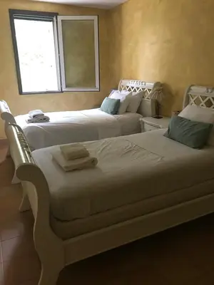 a bedroom with two beds and a window at Villa Neville in Châteaurenard
