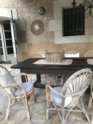 a patio with a couch and chairs under a wooden roof at Villa Neville in Châteaurenard