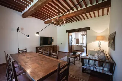 a living room with a wooden table and a couch at Domaine de Saint Pons in Villars