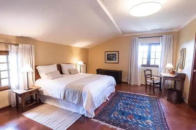 a bedroom with a bed and a table and chairs at Domaine de Saint Pons in Villars