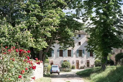 a white house with a car parked in front of it at Domaine de Saint Pons in Villars