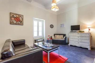 a living room with a couch and a table at Bastide de Fanny in Rognes