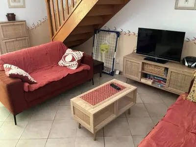 a living room with a red couch and a tv at Les Cigales in Saint-Andiol