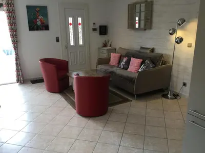 a living room with a couch and red chairs at Beautiful provencal vacation rental in L'Isle sur la Sorgue in LʼIsle-sur-la-Sorgue