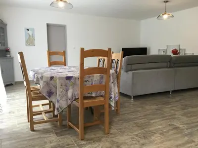 a dining room table with chairs and a couch at A pretty family house located in a tranquil area with a pretty view of the Luberon range. in Les Taillades