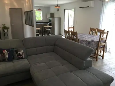 a living room with a couch and a table at A pretty family house located in a tranquil area with a pretty view of the Luberon range. in Les Taillades