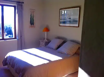 a bedroom with a bed and a window at OUSTAU DE PIERA in Gordes
