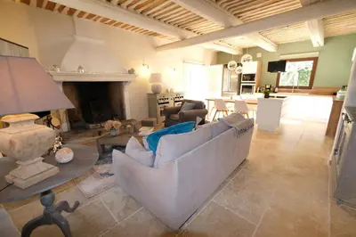 a living room with a couch and a fireplace at superb prestigious mas with pool in the countryside of caumont sur durance, close to avignon, sleeps 8 in Caumont-sur-Durance