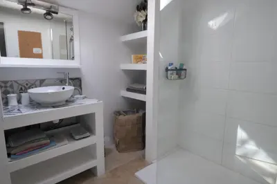 a white bathroom with a sink and a shower at superb prestigious mas with pool in the countryside of caumont sur durance, close to avignon, sleeps 8 in Caumont-sur-Durance