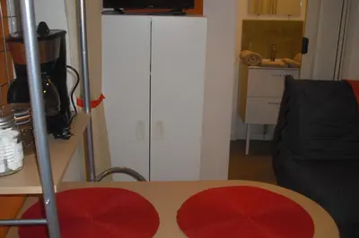 a room with a table and a white cabinet at Lou mas li Pitchoun 