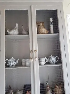 a cupboard filled with lots of dishes and china at fleur de garance in Le Thor