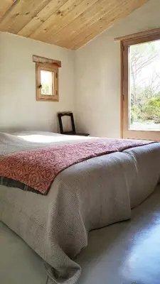 a bedroom with a large bed with a window at La petite maison in Aix-en-Provence