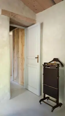 a room with a door and a cart in front of it at La petite maison in Aix-en-Provence