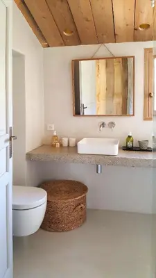 a bathroom with a toilet and a sink and a mirror at La petite maison in Aix-en-Provence