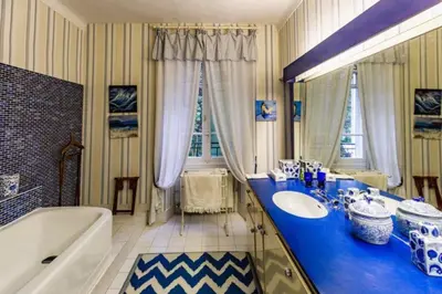 a bathroom with a tub and a sink and a bath tub at Le Domaine de Saint Veran in Orgon