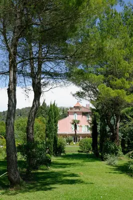 a house in the middle of a field with trees at Le Domaine de Saint Veran in Orgon