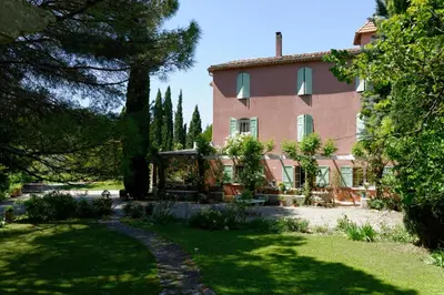 a large house with a garden in front of it at Le Domaine de Saint Veran in Orgon