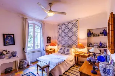 a bedroom with a bed and a ceiling fan at Le Domaine de Saint Veran in Orgon