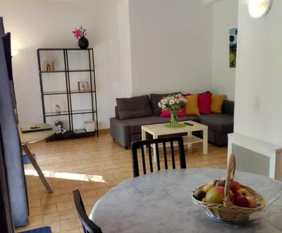 a living room with a table with a bowl of fruit at Le Moulin Des Ocres in Apt