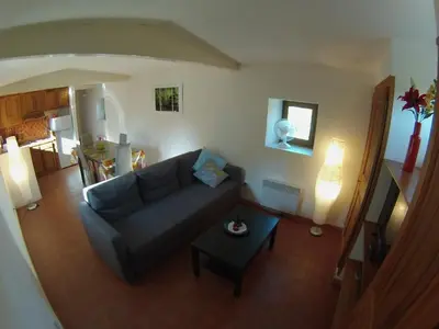 a living room with a couch and a table at Le Moulin Des Ocres in Apt