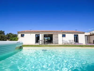 a villa with a swimming pool in front of a house at Holiday Home L'Oliveraie by Interhome in Saint-Didier