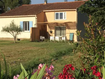 a house in a yard with flowers in front of it at LA RESPELIDANE in Caromb