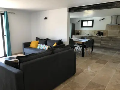 a living room with two couches and a table at Mas Eléhis Gîtes en Provence in Pernes-les-Fontaines