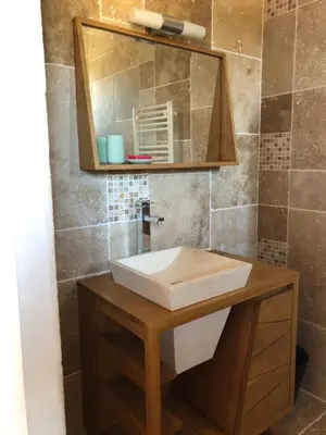 a bathroom with a sink and a mirror at Mas Eléhis Gîtes en Provence in Pernes-les-Fontaines
