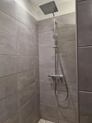a shower with a shower head in a bathroom at La Gourmandine in Saint-Andiol
