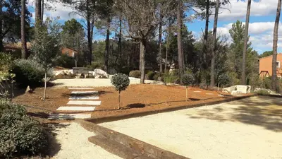 a garden with a tree in the middle of it at Les Oursillons in Roussillon