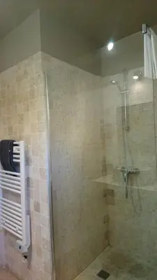 a bathroom with a shower with a glass door at Un Coin De Luberon in LʼIsle-sur-la-Sorgue