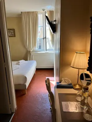 a hotel room with a bed and a window at Les Quatre Dauphins in Aix-en-Provence