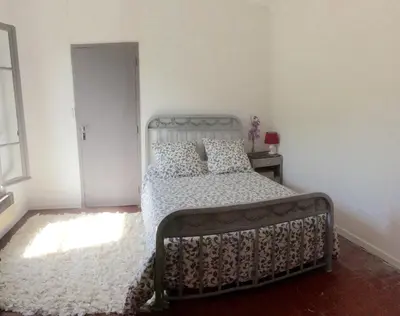 a bedroom with a bed and a window at Fontaine-de-Vaucluse : maison avec vues in Fontaine-de-Vaucluse