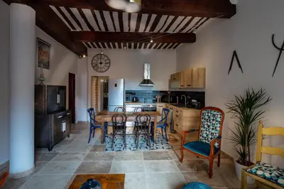 a kitchen and dining room with a table and chairs at La terrasse de Tiss in Bédoin