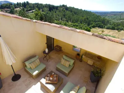 an overhead view of a balcony with chairs and a table at Luxurious Provencal Village House, Walk to Village Pool in Rustrel